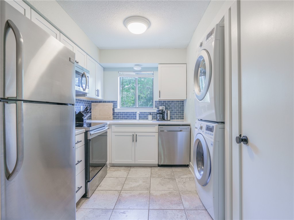 2328 Sadler Road, Unit 1E Fernandina Beach, FL 32034 - Photo 6 of 31 a kitchen with a refrigerator sink and cabinets