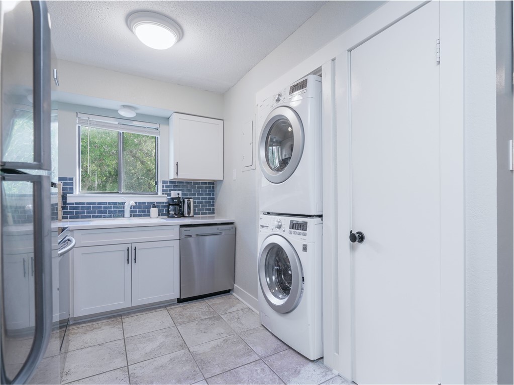2328 Sadler Road, Unit 1E Fernandina Beach, FL 32034 - Photo 7 of 31 a utility room with sink dryer and washer