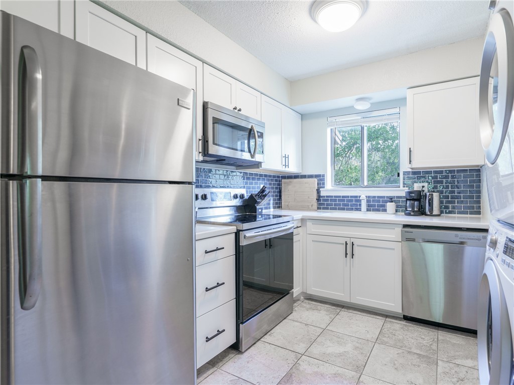 2328 Sadler Road, Unit 1E Fernandina Beach, FL 32034 - Photo 8 of 31 a white refrigerator freezer sitting inside of a kitchen