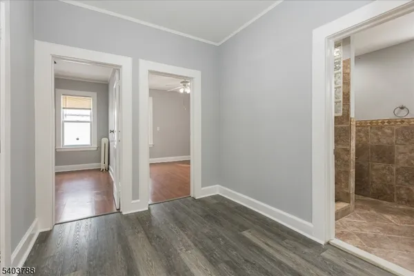 a view of a hallway with wooden floor