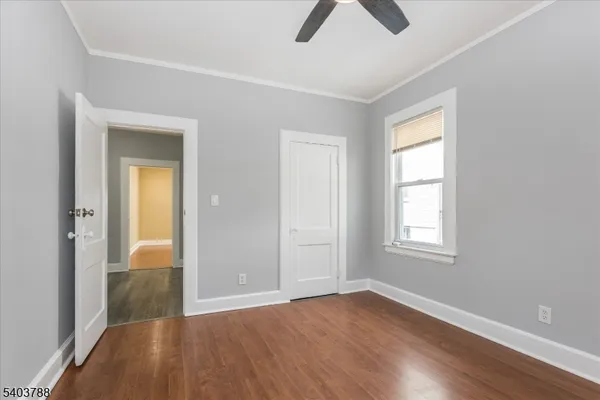 an empty room with closet and windows