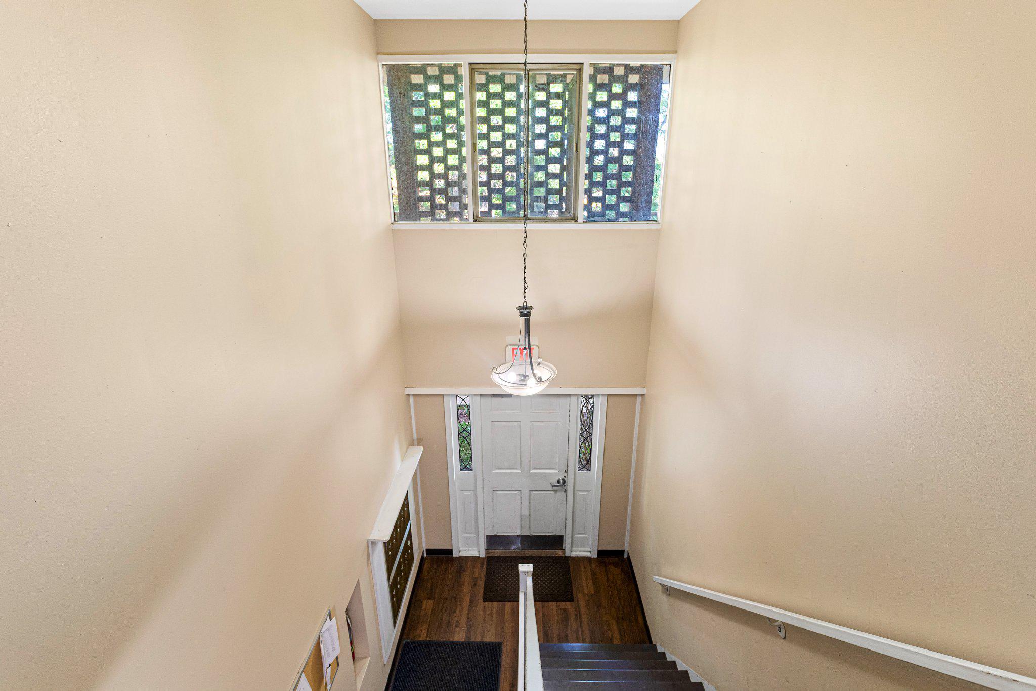 5613 Franconia Road, Unit 303 Alexandria, VA 22310 - Photo 3 of 27 a view of a hallway with wooden floor and staircase