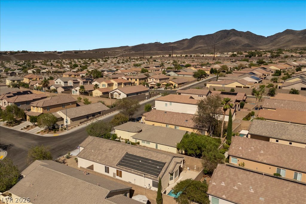 2627 Dirleton Place Henderson, NV 89044 - Photo 39 of 42 An aerial perspective showcases a residential neighborhood nestled against a backdrop of distant hills.