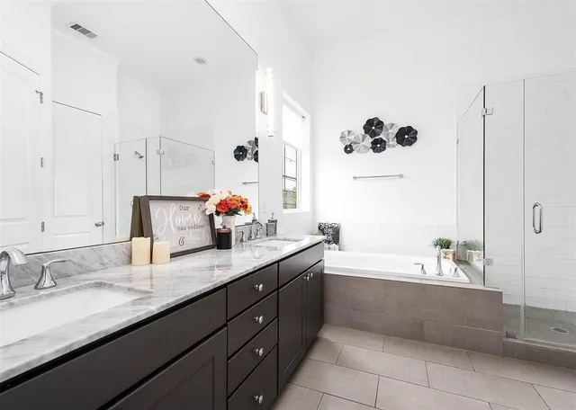 a bathroom with a granite countertop sink mirror and bathtub