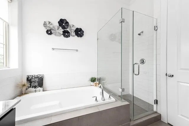 a bathroom with a tub and shower