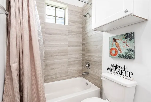 a bathroom with a bathtub and a shower curtain