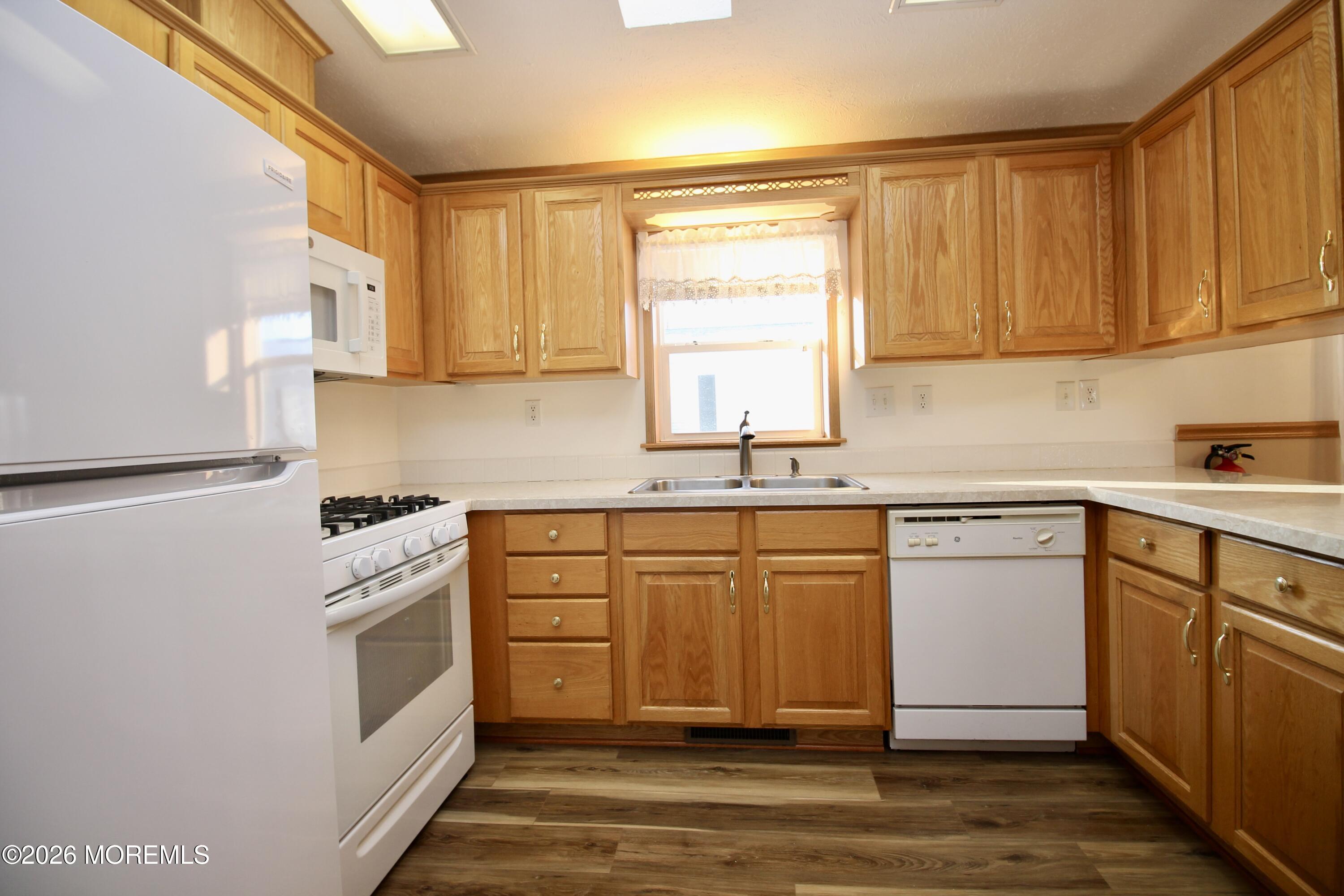 75 Robin Place Freehold, NJ 07728 - Photo 15 of 36 a kitchen with stainless steel appliances granite countertop a sink stove and refrigerator