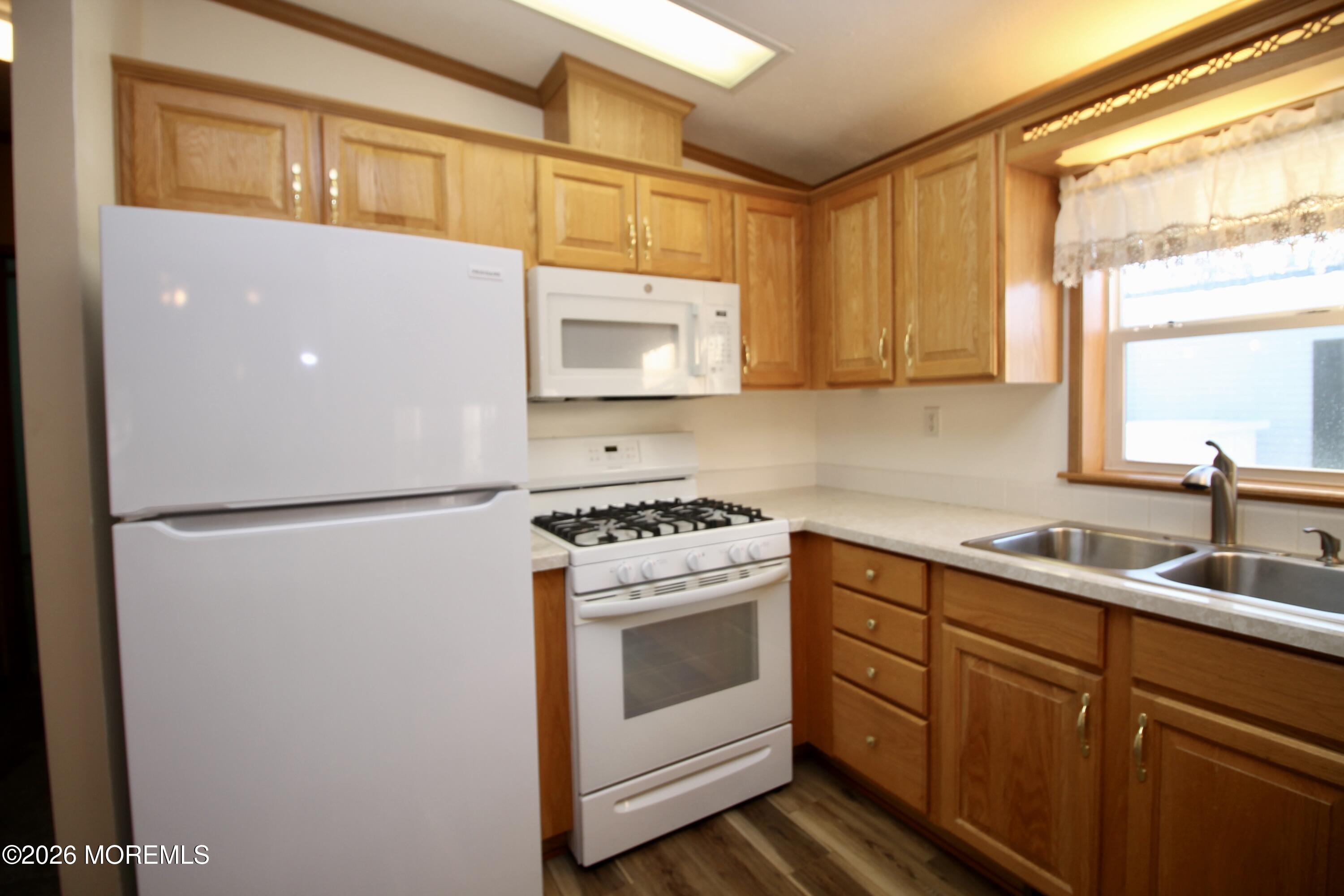 75 Robin Place Freehold, NJ 07728 - Photo 16 of 36 a kitchen with a refrigerator sink and cabinets