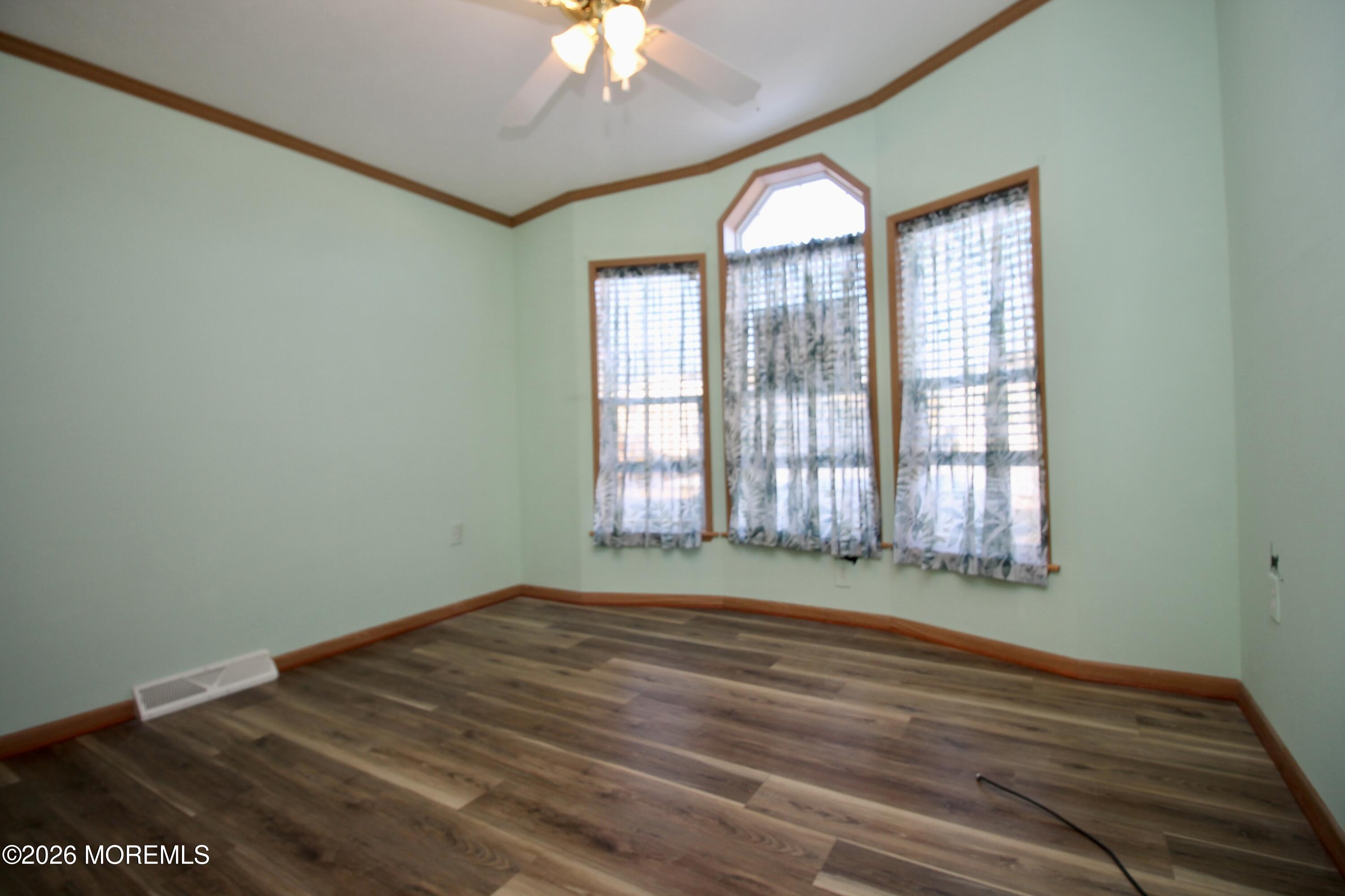 75 Robin Place Freehold, NJ 07728 - Photo 22 of 36 a view of an empty room with a window and wooden floor
