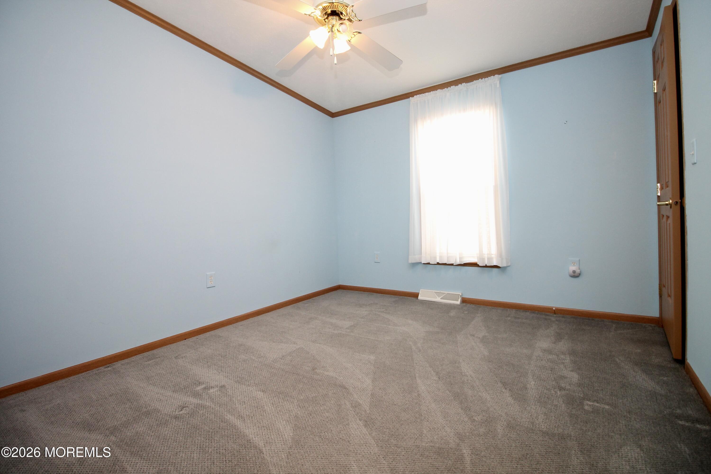75 Robin Place Freehold, NJ 07728 - Photo 23 of 36 an empty room with a window and a fan