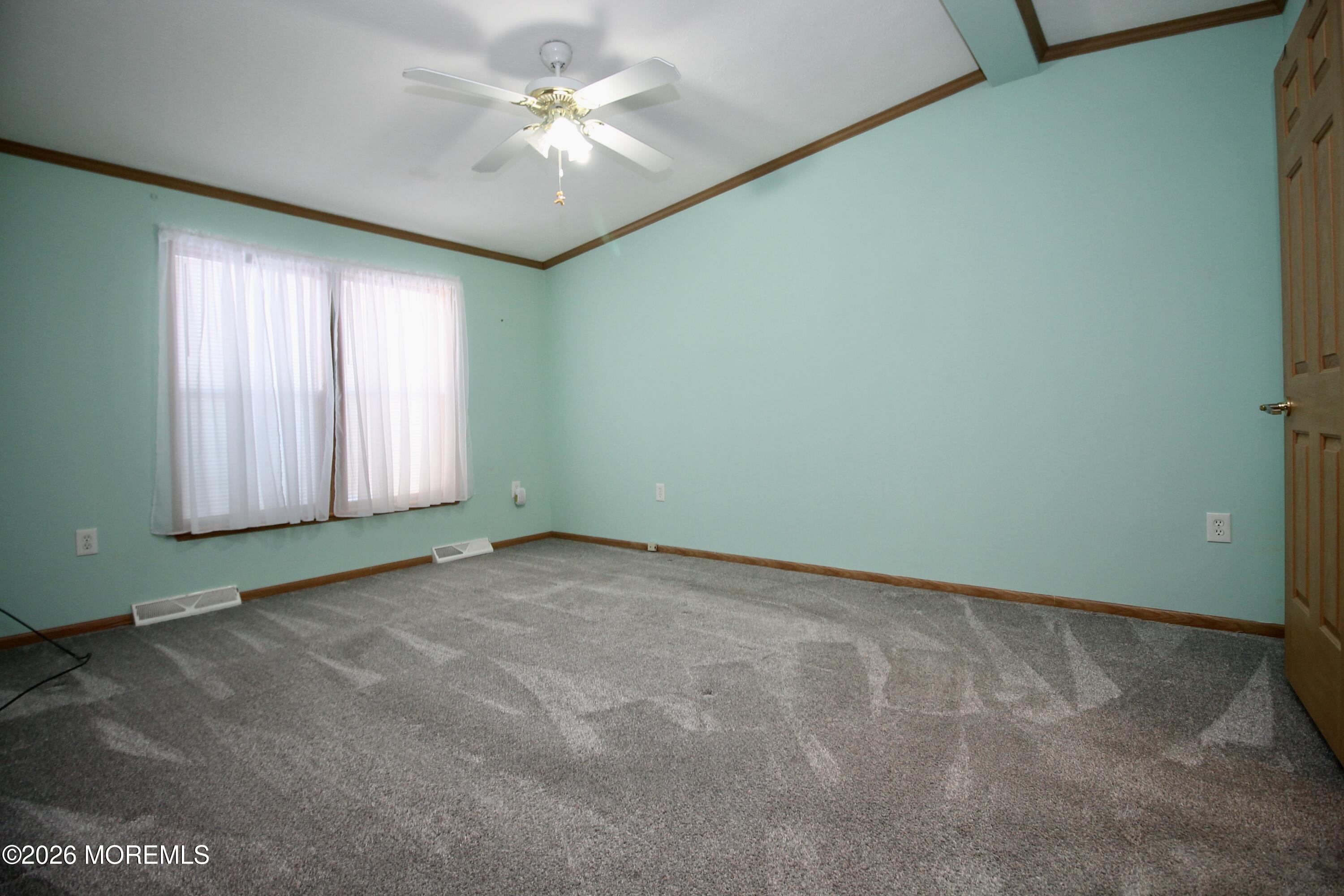 75 Robin Place Freehold, NJ 07728 - Photo 25 of 36 an empty room with a window and a ceiling fan