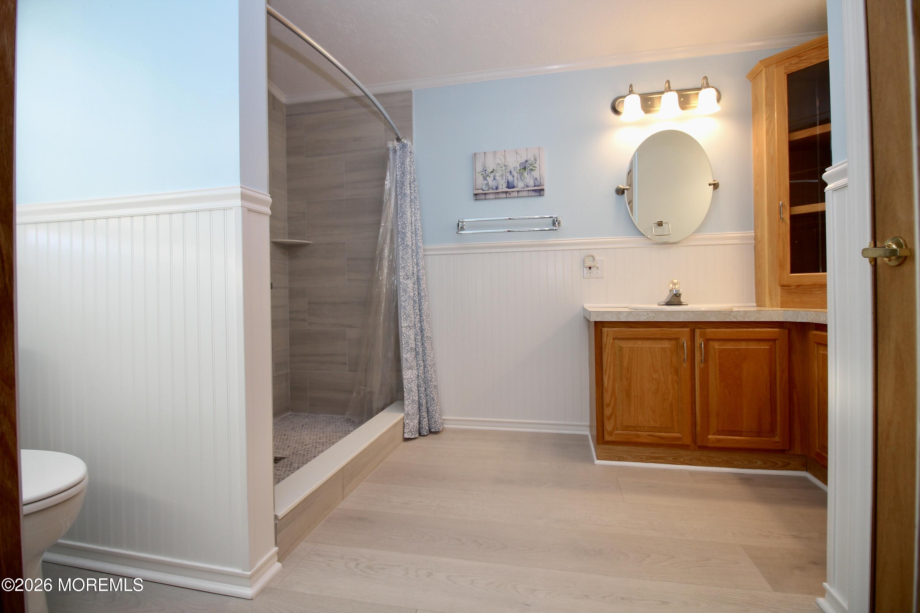 75 Robin Place Freehold, NJ 07728 - Photo 28 of 36 a bathroom with a sink a mirror and a toilet