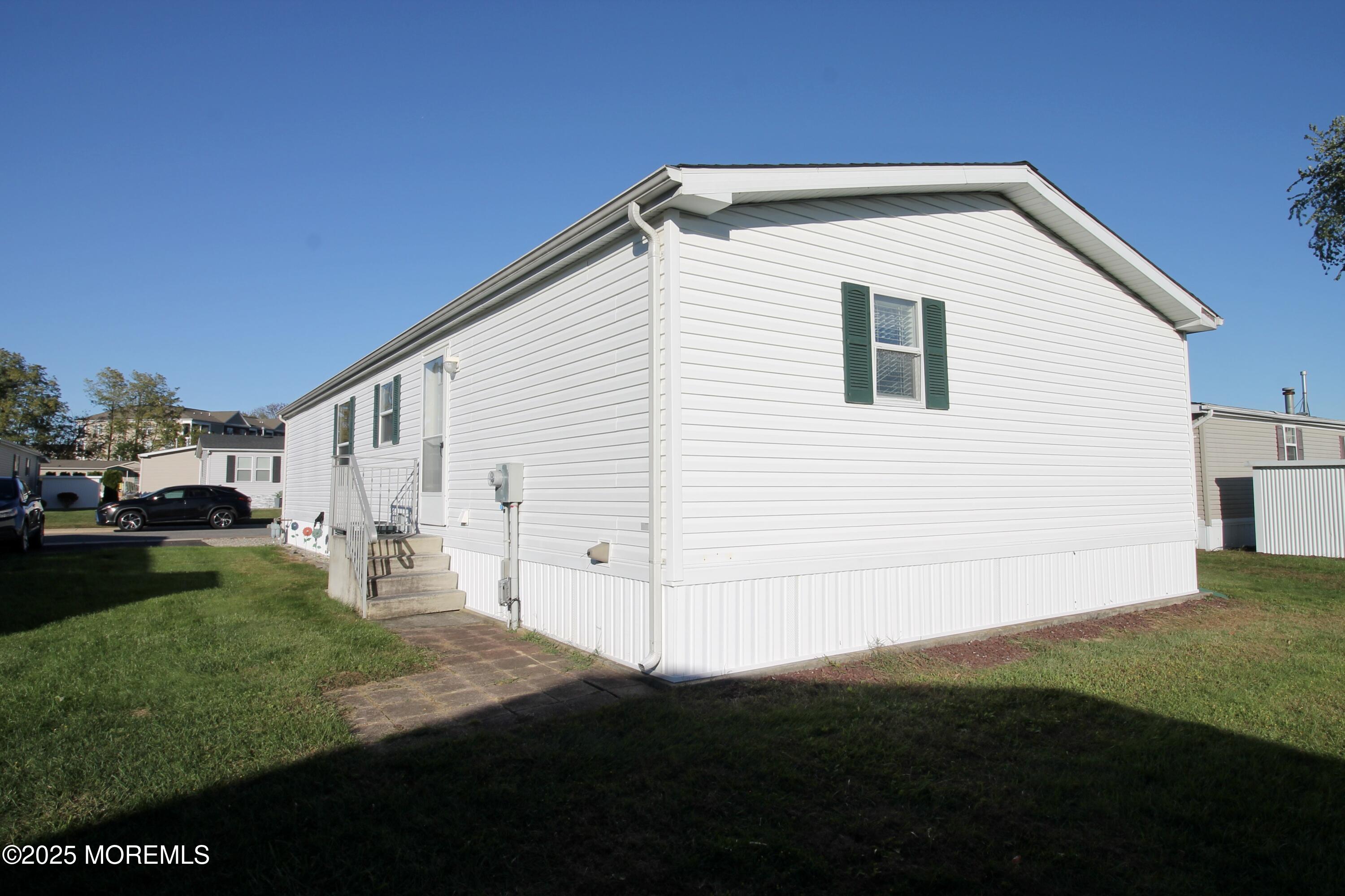 75 Robin Place Freehold, NJ 07728 - Photo 35 of 36 a view of a white house with yard