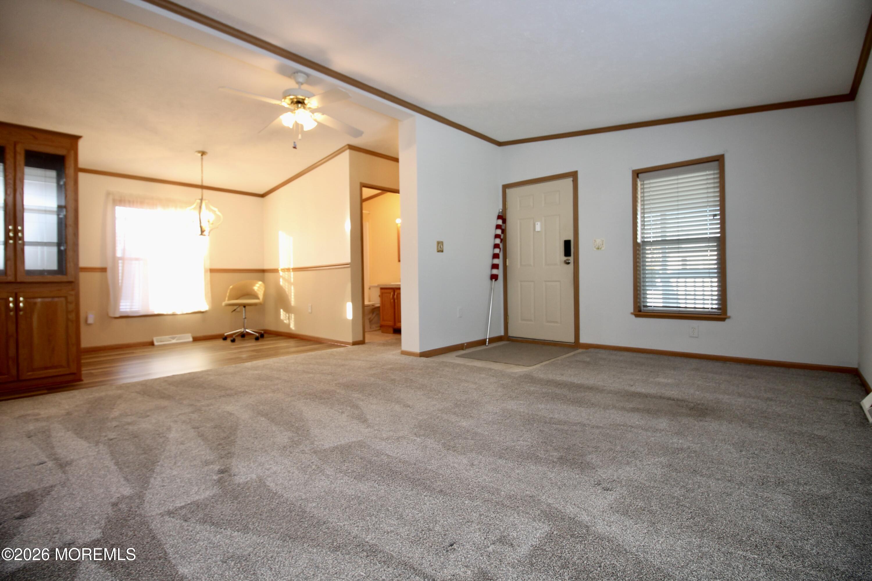 75 Robin Place Freehold, NJ 07728 - Photo 10 of 36 an empty room with a fireplace and windows