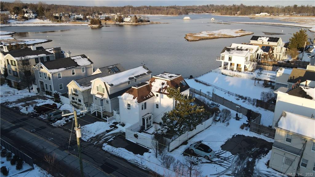 209 Hillspoint Road Westport, CT 06880 - Photo 1 of 1 AERIAL VIEW OF THE BEACH HOME AND THE MILL POND. 209 HILLSPOINT IS THE HOME IN THE FRONT WITH THE BROWN ROOF.