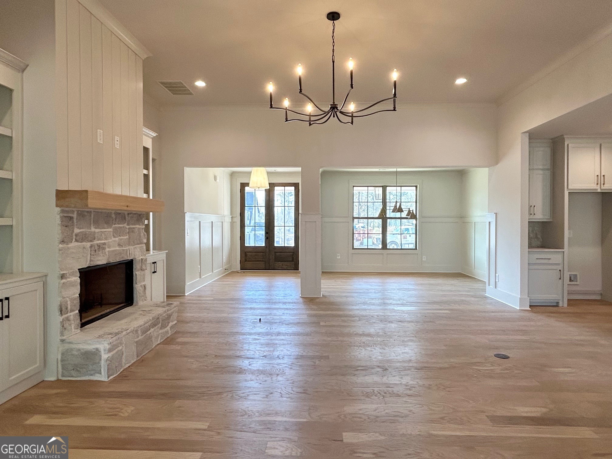 158 Snug Harbor Place Newnan, GA 30263 - Photo 36 of 94 a view of an empty room with wooden floor fireplace and a window