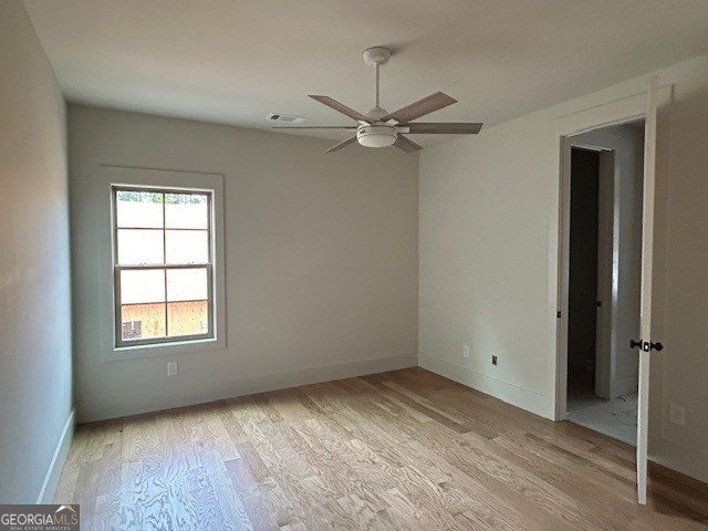 158 Snug Harbor Place Newnan, GA 30263 - Photo 58 of 94 an empty room with a window and ceiling fan