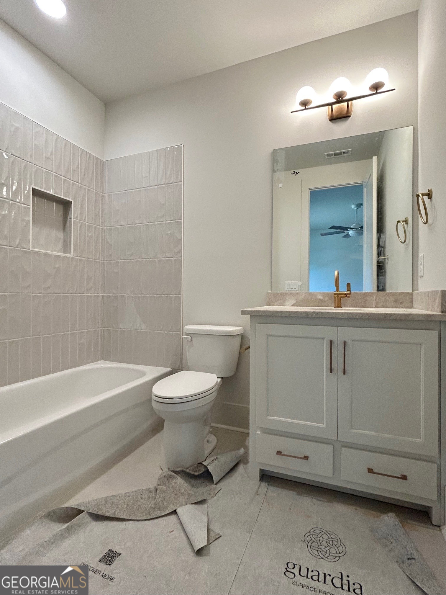 158 Snug Harbor Place Newnan, GA 30263 - Photo 60 of 94 a bathroom with a toilet a sink and mirror