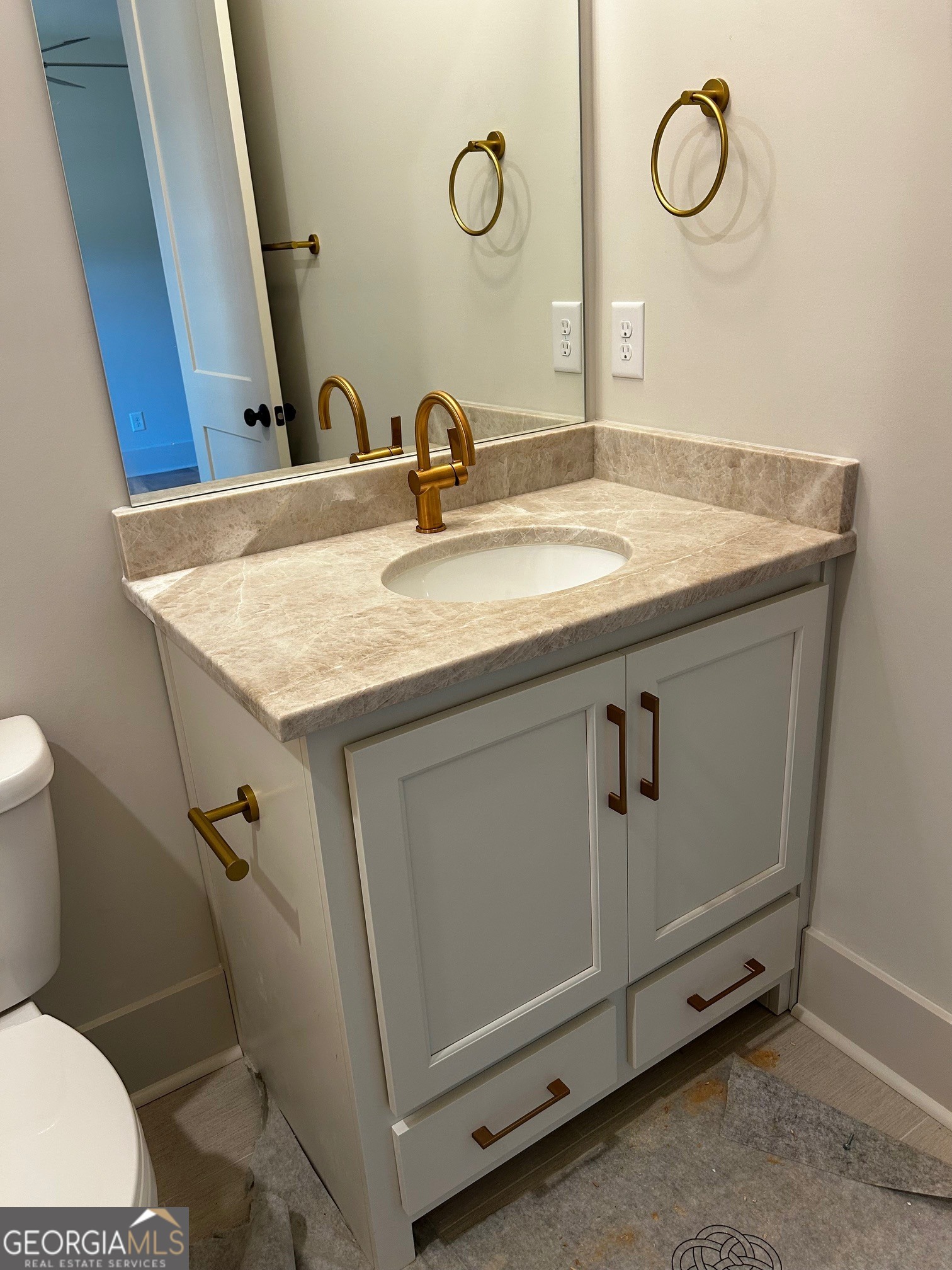 158 Snug Harbor Place Newnan, GA 30263 - Photo 61 of 94 a bathroom with a granite countertop sink a toilet and a mirror