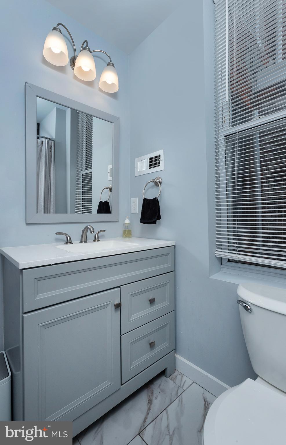 1750 North 25th Street Philadelphia, PA 19121 - Photo 23 of 37 a bathroom with a toilet sink and mirror