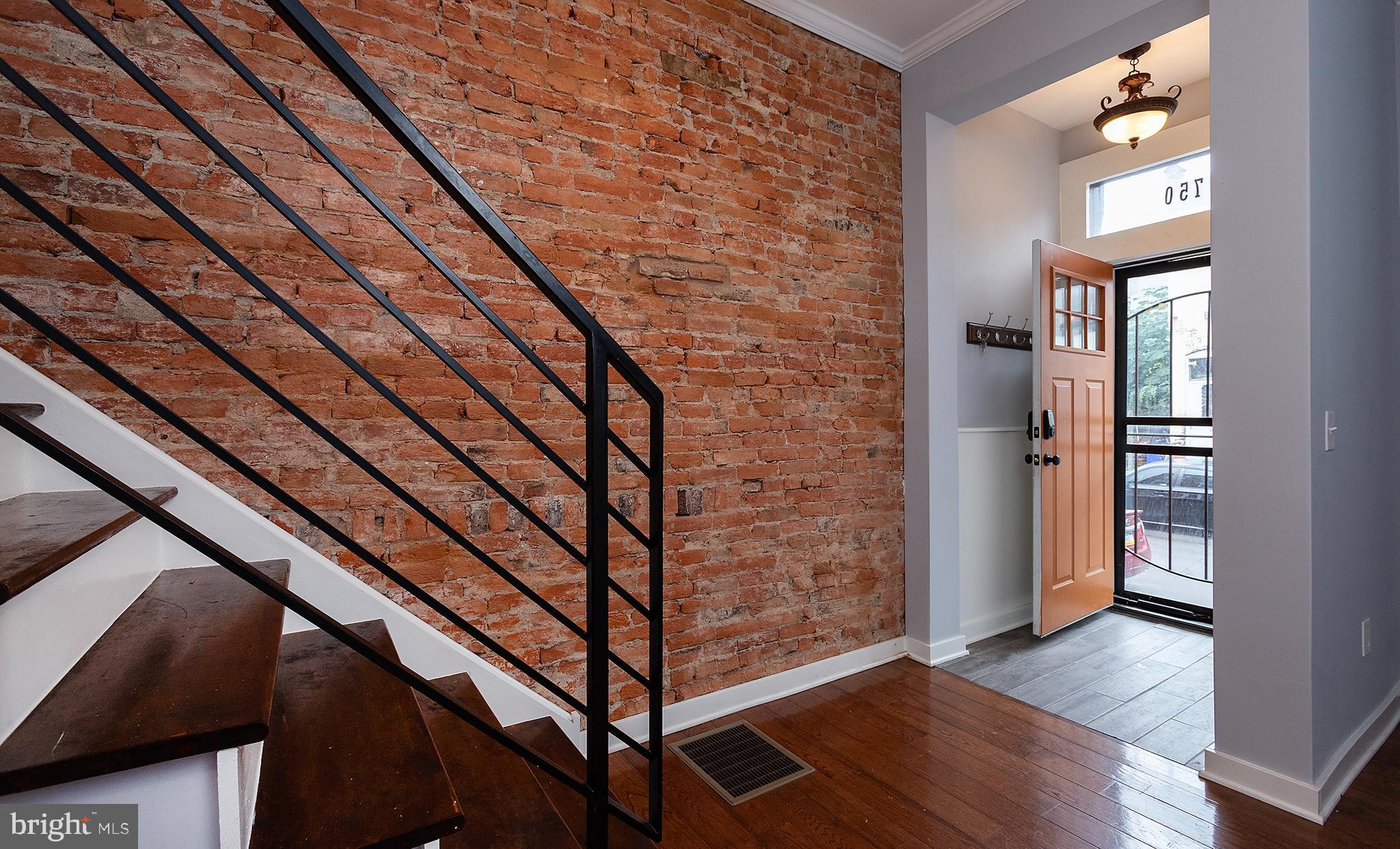 1750 North 25th Street Philadelphia, PA 19121 - Photo 3 of 37 a view of an entryway with wooden floor and door