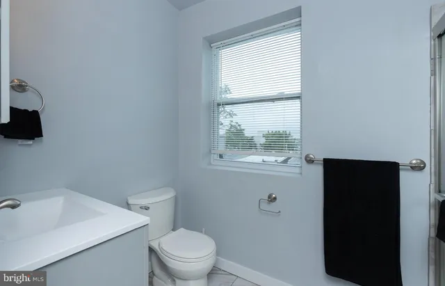 a white toilet sitting next to a bathroom sink