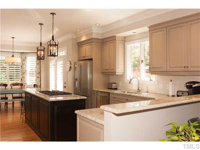 3928 Westchester Road Durham, NC 27707 - Photo 5 of 21 Granite counter tops with stainless single bowl sink. Ceramic Tile backsplash, 42 Inch Kitchen Cabinets, dovetailed self closing doors & center island with gas range.