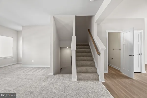 a view of entryway with wooden floor and stairs
