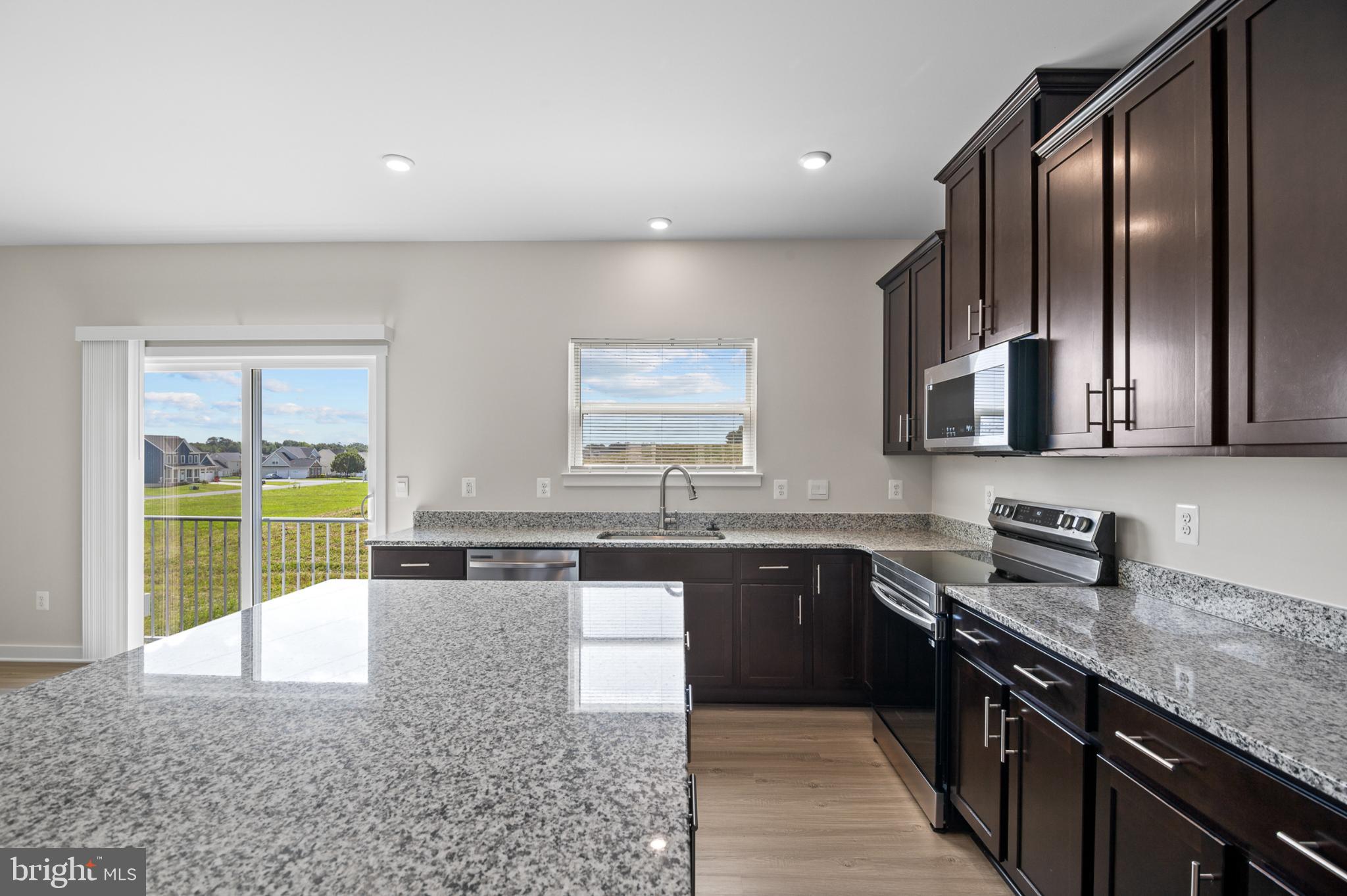 21 Lyriq Court Inwood, WV 25428 - Photo 21 of 40 a large kitchen with granite countertop a sink a stove and cabinets