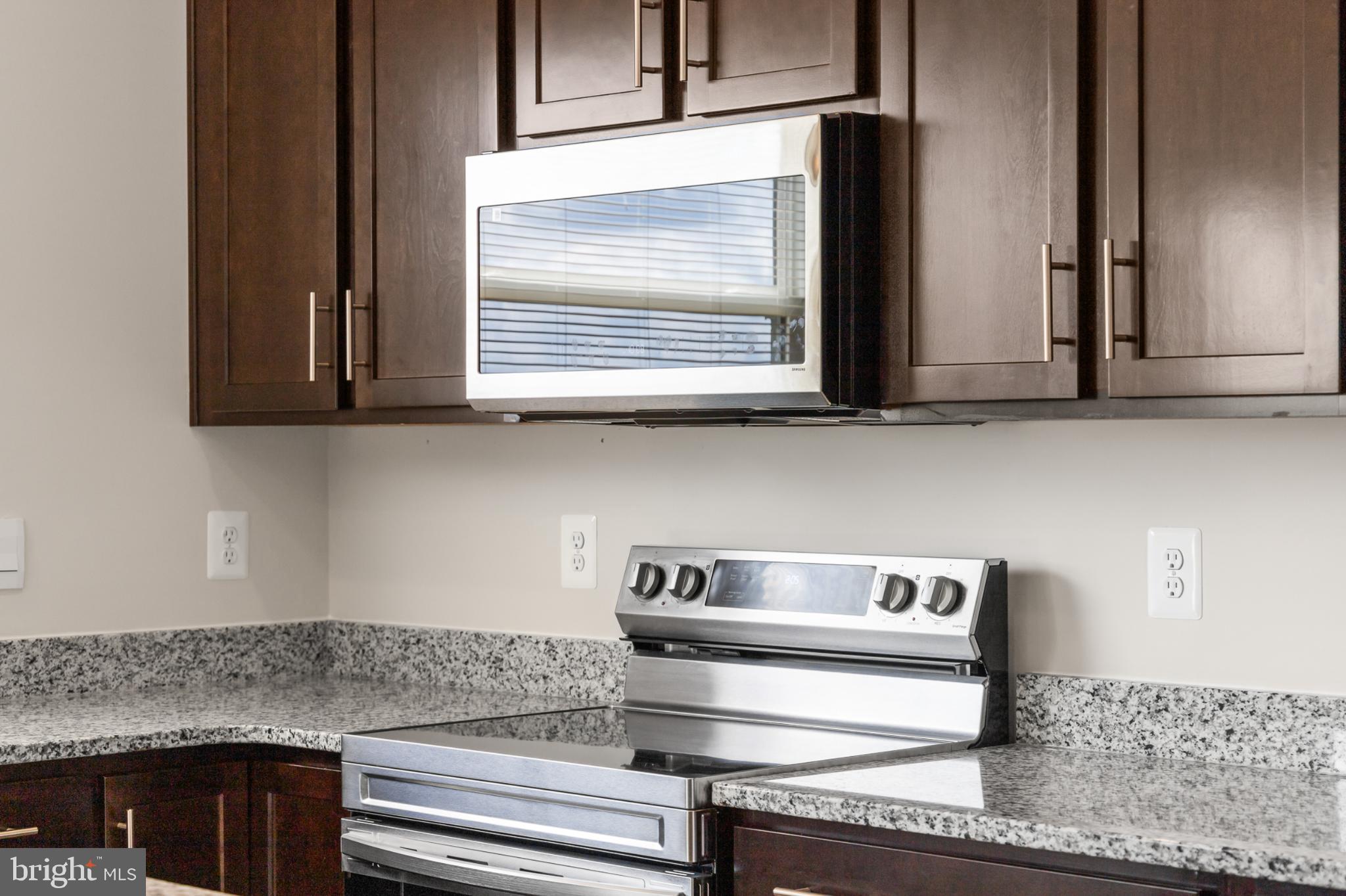 21 Lyriq Court Inwood, WV 25428 - Photo 23 of 40 a kitchen with stainless steel appliances granite countertop white cabinets and a counter top