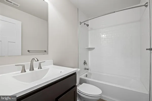 a bathroom with a sink mirror toilet and bathtub