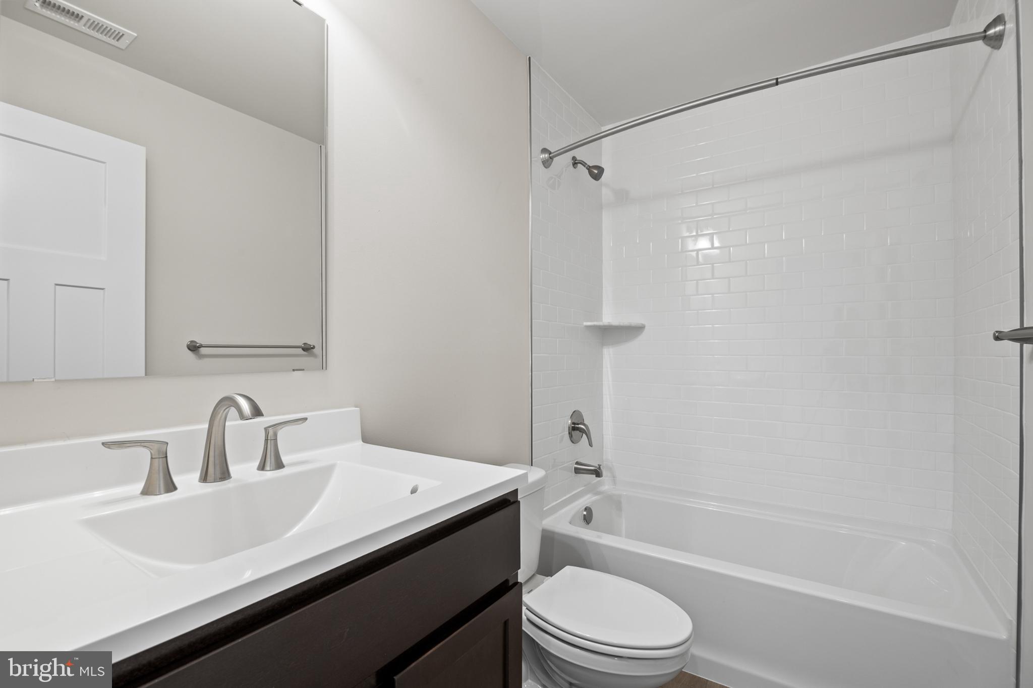 21 Lyriq Court Inwood, WV 25428 - Photo 27 of 40 a bathroom with a sink mirror toilet and bathtub