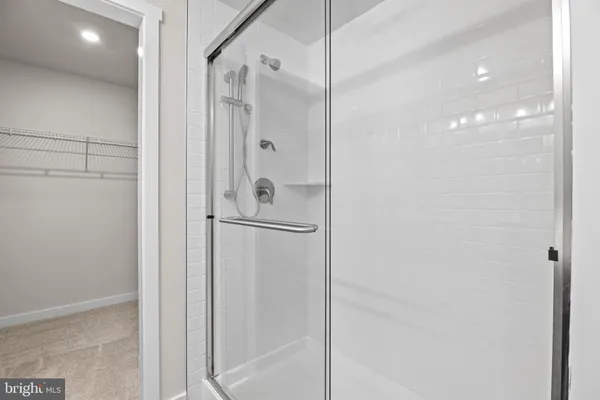 a bathroom with a glass shower door