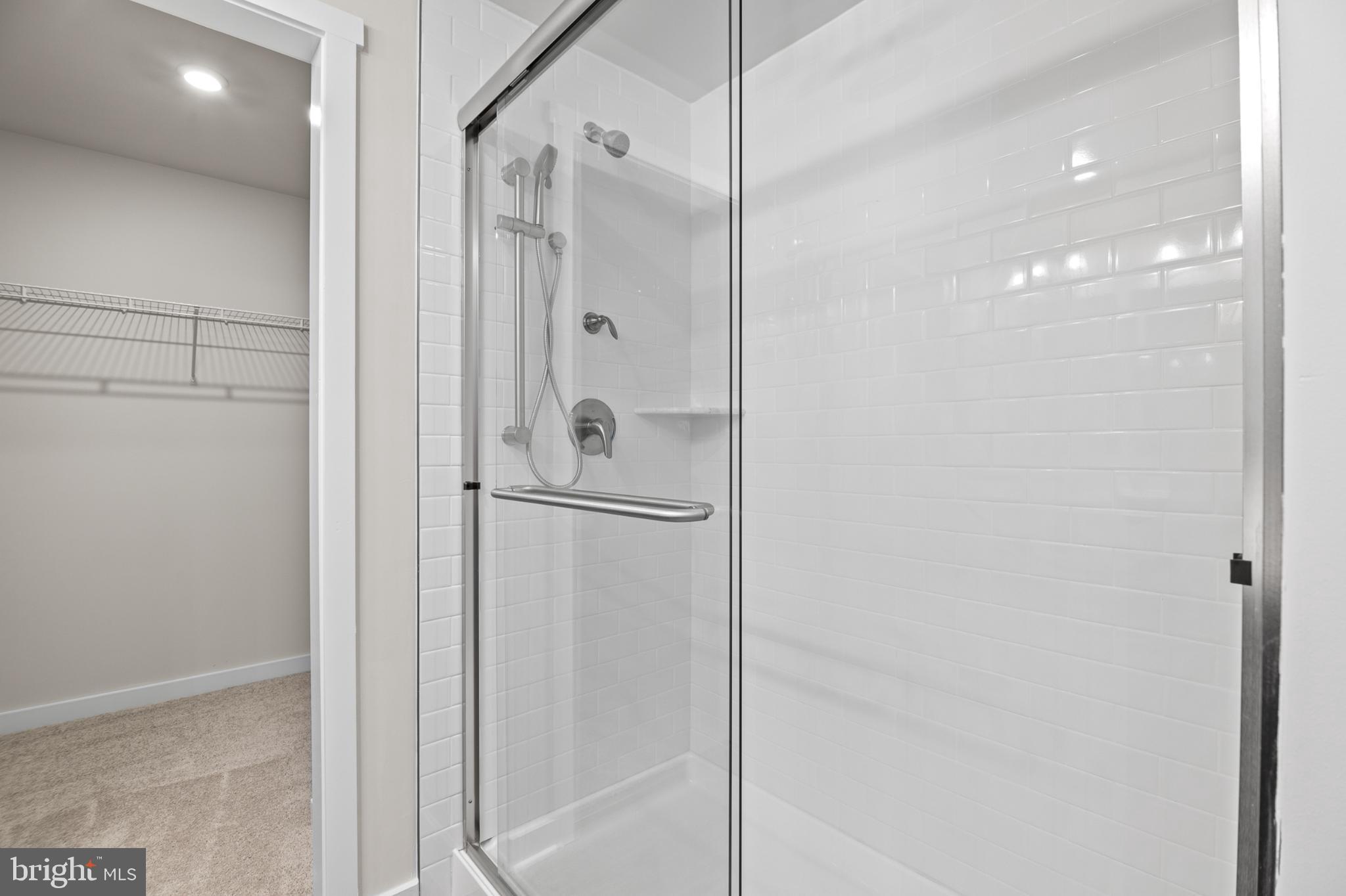 21 Lyriq Court Inwood, WV 25428 - Photo 35 of 40 a bathroom with a glass shower door