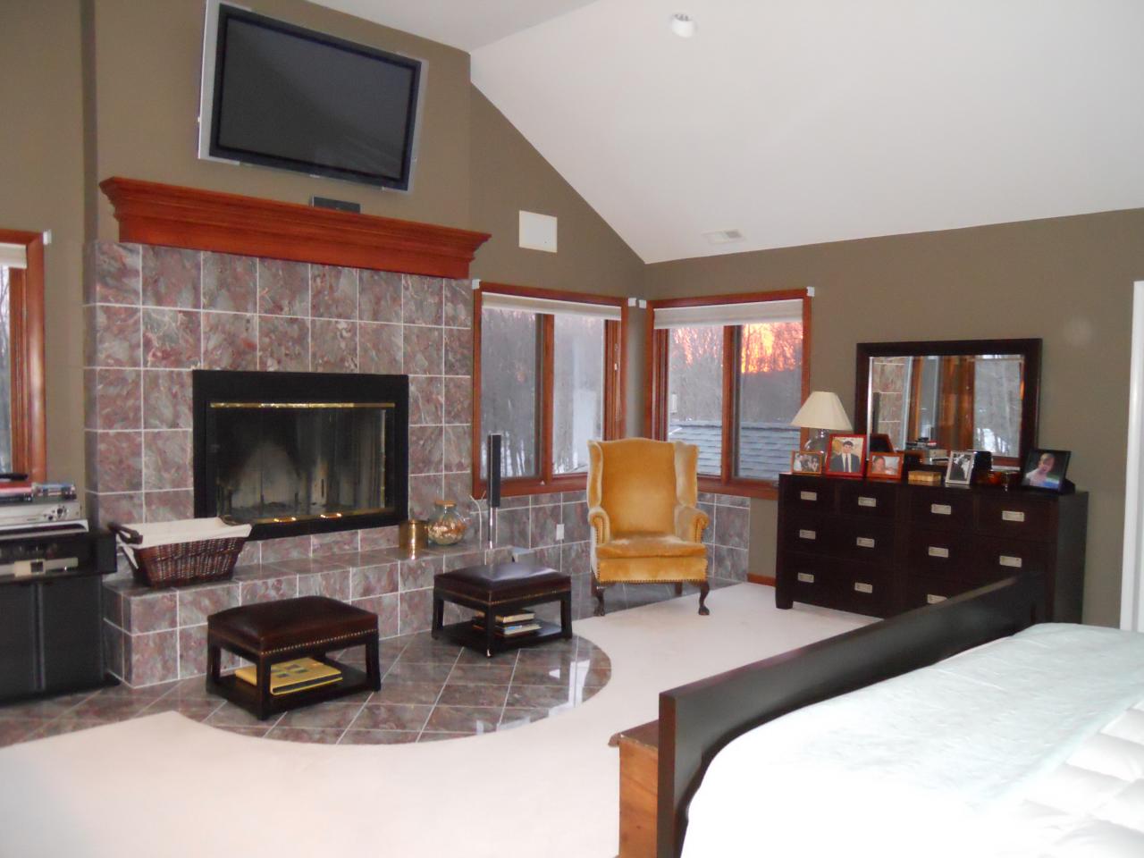 275 Hupi Road Monterey, MA 01245 - Photo 21 of 40 a bedroom with a bed and a fireplace