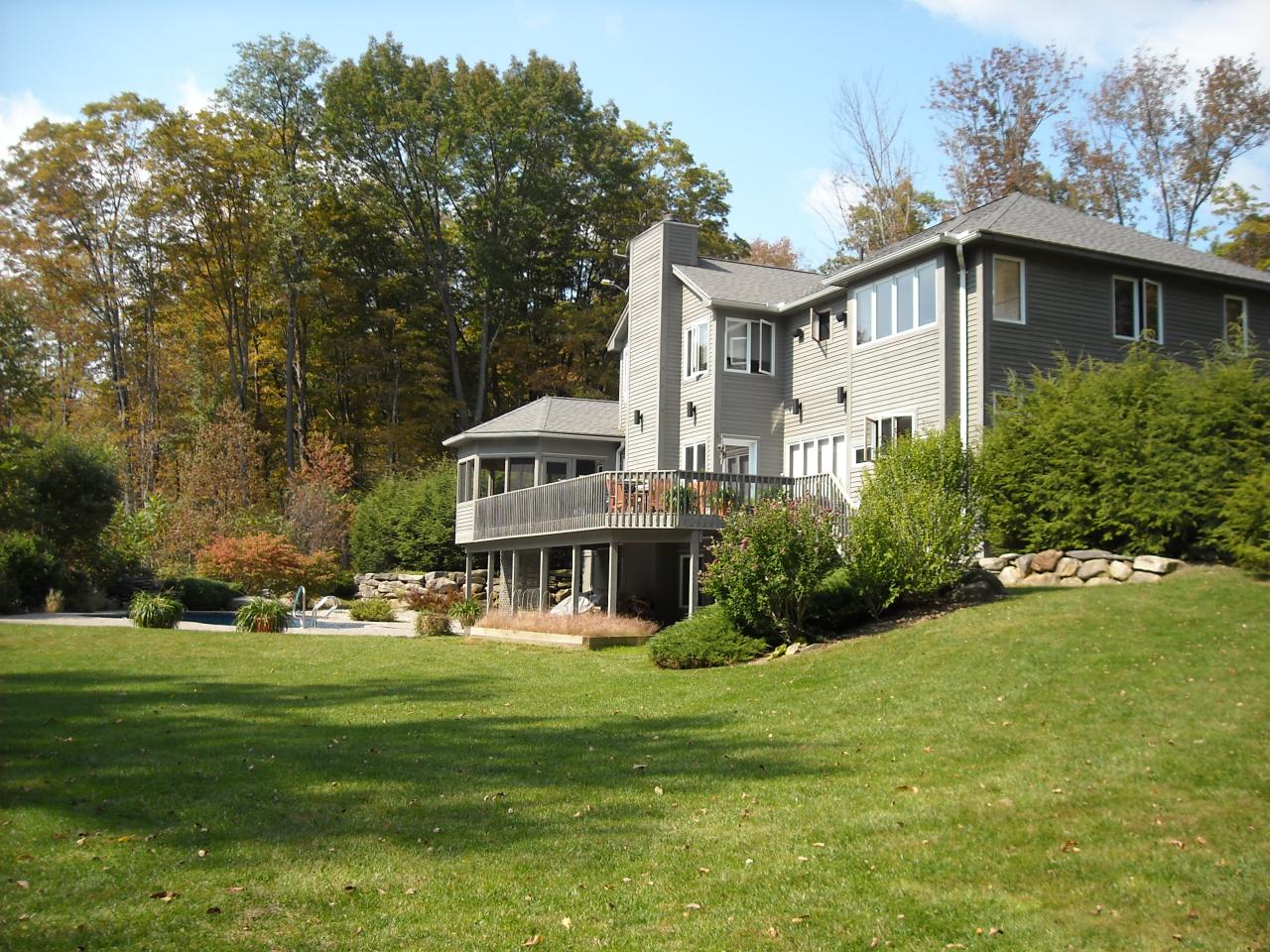 275 Hupi Road Monterey, MA 01245 - Photo 37 of 40 a big white house with a big yard and large trees