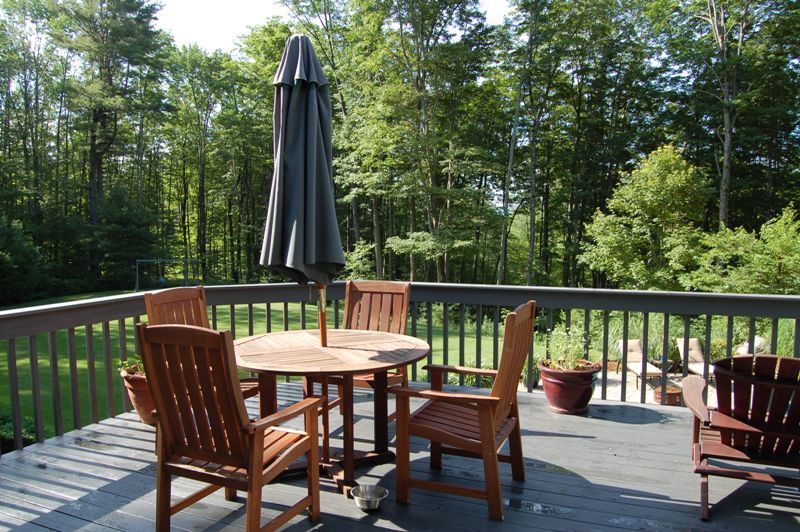 275 Hupi Road Monterey, MA 01245 - Photo 40 of 40 a view of a deck with a table and chairs with wooden floor and fence