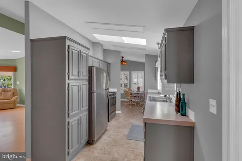 a kitchen with stainless steel appliances granite countertop a refrigerator and a sink