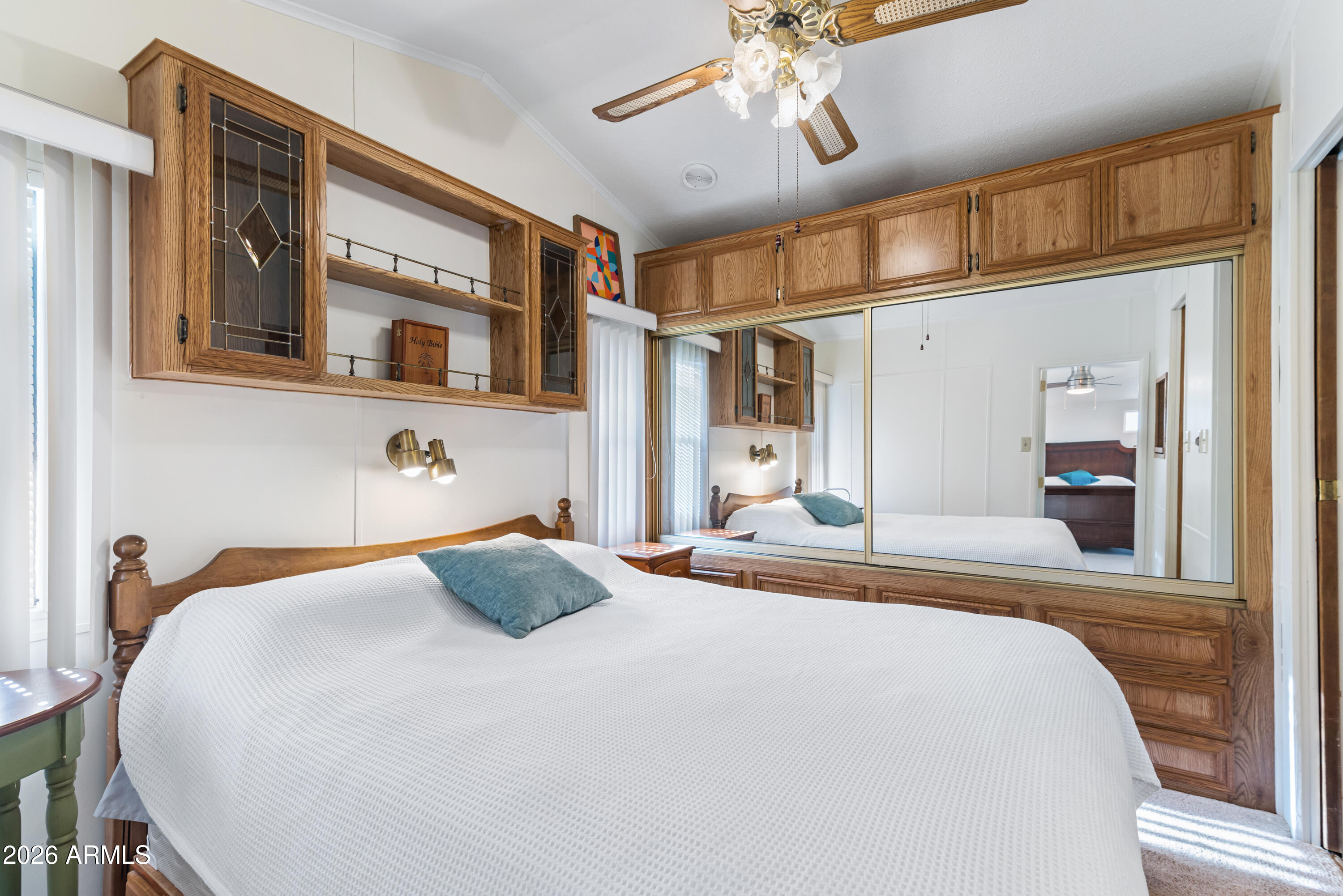 111 South Greenfield Road, Unit 547 Mesa, AZ 85206 - Photo 16 of 38 a bedroom with a bed and a chandelier