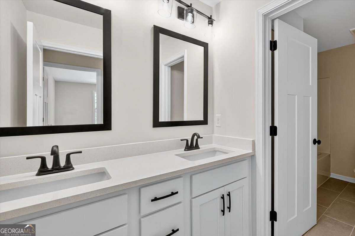 1570 The Rock Road Thomaston, GA 30286 - Photo 16 of 53 a bathroom with double vanity sinks and a mirror