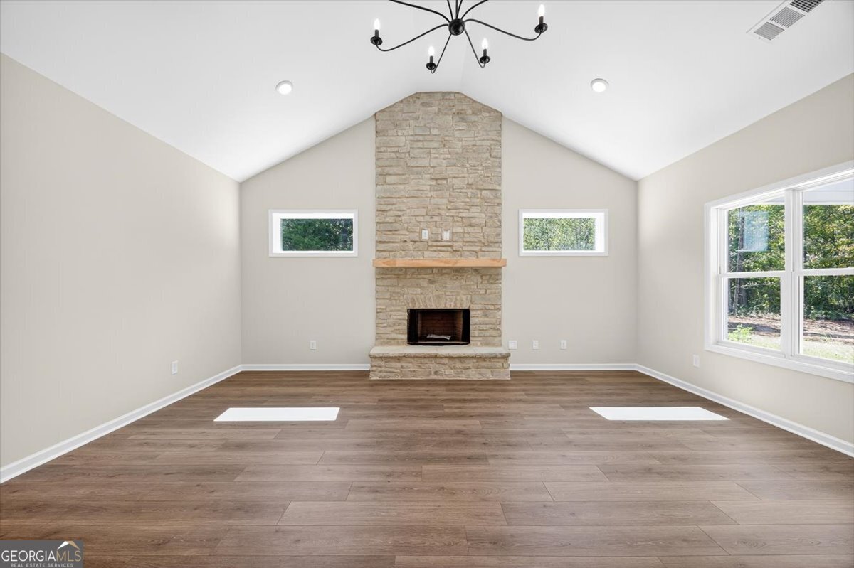 1570 The Rock Road Thomaston, GA 30286 - Photo 27 of 53 an empty room with windows and fireplace
