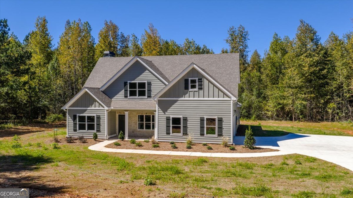 1570 The Rock Road Thomaston, GA 30286 - Photo 7 of 53 a front view of a house with garden and trees