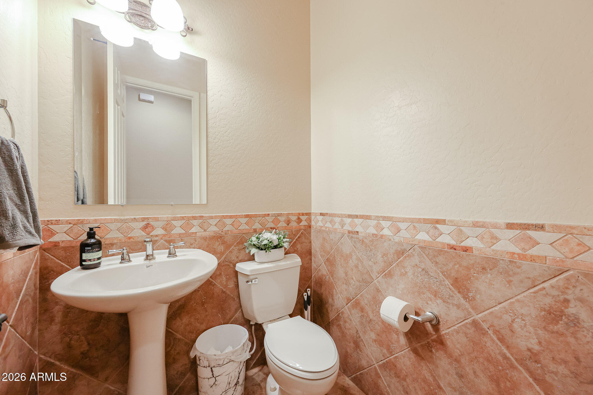 18175 West Narramore Road Goodyear, AZ 85338 - Photo 22 of 72 a bathroom with a toilet sink and mirror