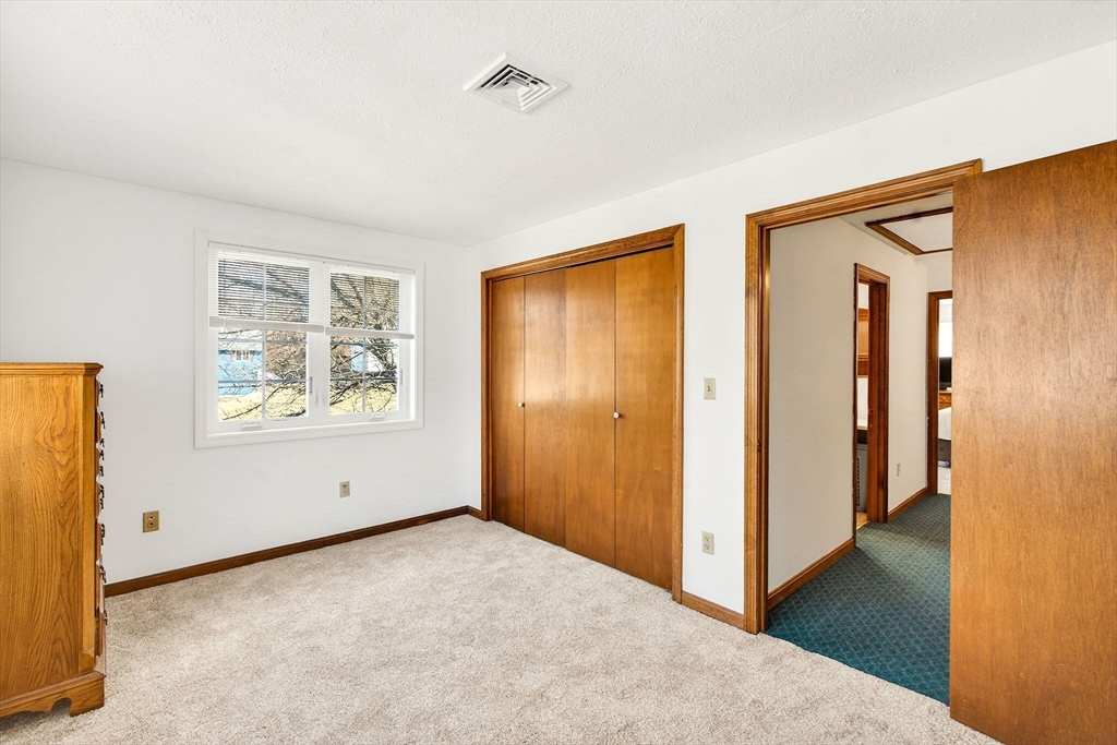 61 Fox Meadow Road, Unit A Leominster, MA 01453 - Photo 17 of 38 a view of an empty room with wooden floor and a window