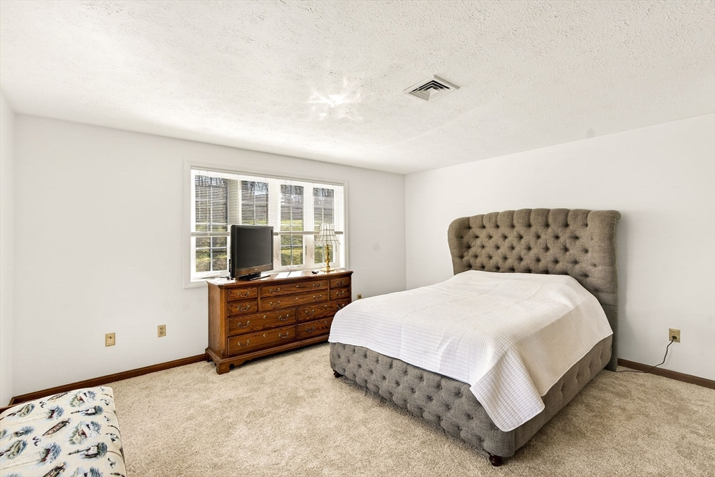 61 Fox Meadow Road, Unit A Leominster, MA 01453 - Photo 20 of 38 a bedroom with a bed and window