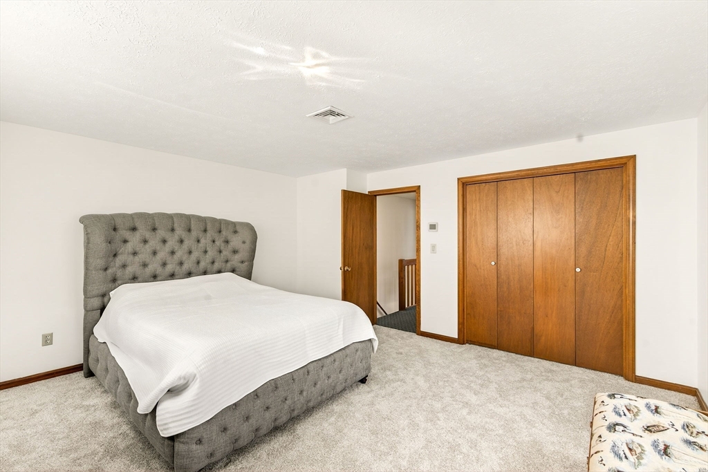 61 Fox Meadow Road, Unit A Leominster, MA 01453 - Photo 21 of 38 a bedroom with a bed and a cabinets