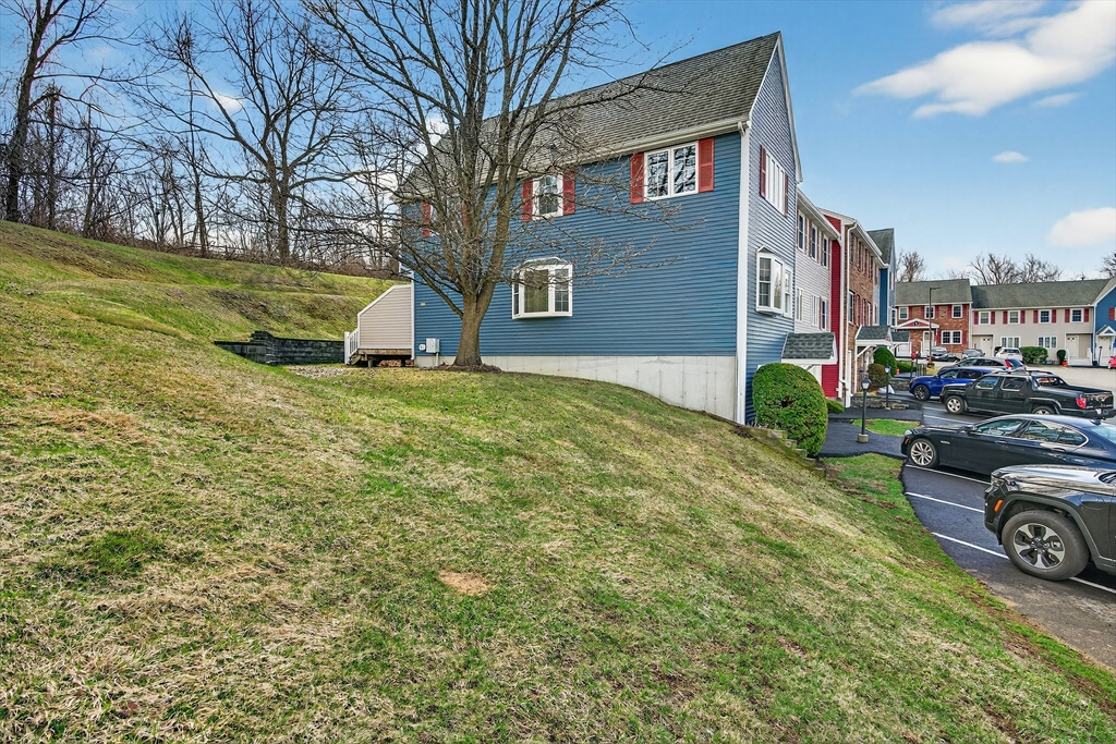 61 Fox Meadow Road, Unit A Leominster, MA 01453 - Photo 32 of 38 a view of a house with a cars park side of a road