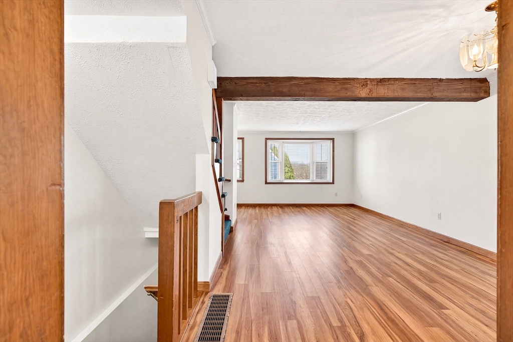 61 Fox Meadow Road, Unit A Leominster, MA 01453 - Photo 7 of 38 a view of an empty room with wooden floor and a window