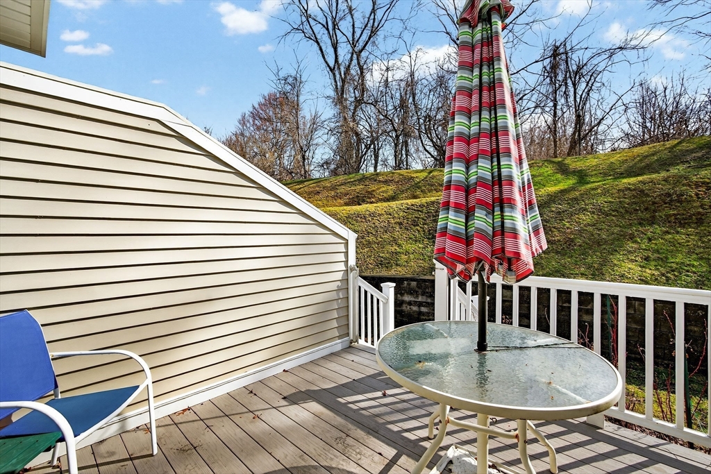61 Fox Meadow Road, Unit A Leominster, MA 01453 - Photo 10 of 38 a backyard of a house with barbeque oven table and chairs