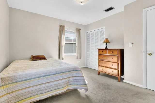 a bedroom with a bed and a closet